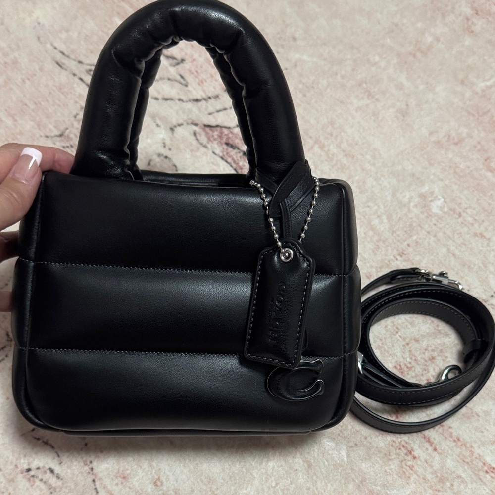 Like new.  Coach Mini pillow tote bag.